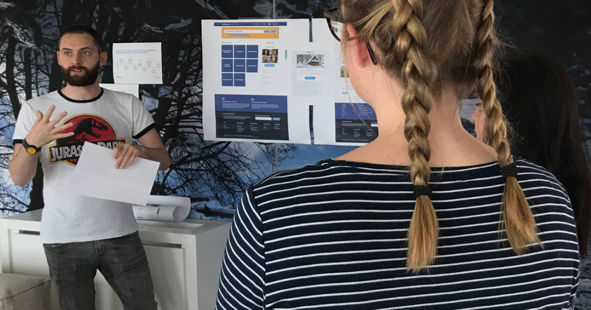 A photo of me doing a UX Crit at Booking.com – these are 10,000% one of the best things a UX designer can do to improve their work.